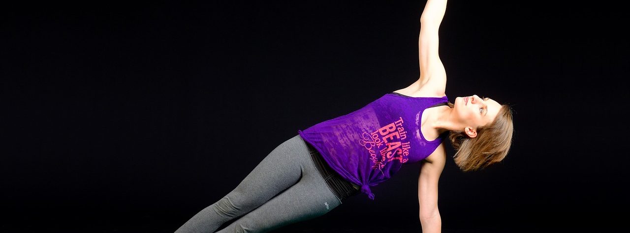 A sexy woman doing side plank