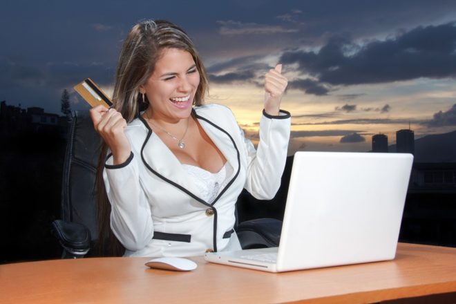 A beautiful and sexy happy woman holding a card on her right hand