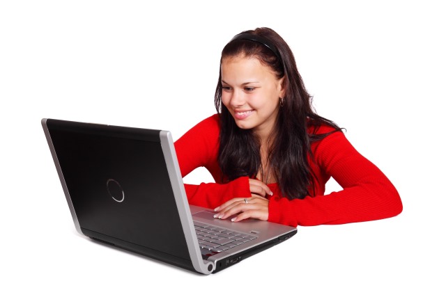 Beautiful woman looking to her black laptop